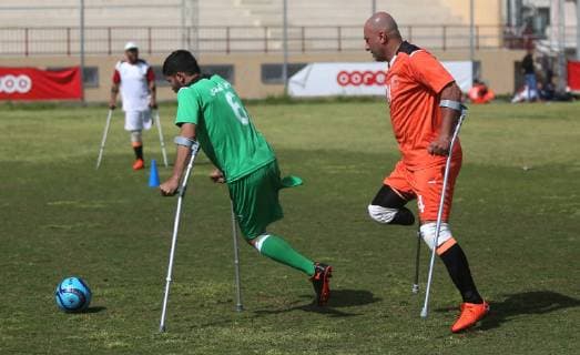 April 13, 2019 - Gaza City, Gaza Strip, Palestinian Territory - Palestinian amputees using crutches play a football match during the first football tournament for amputees, at Palestine Stadium in Gaza city, on April 13, 2019. More than 125 have had amputations shot by Israeli forces during a year of weekly mass protests along the Gaza border, according to Palestinian figures Gaza City Palestinian Territory - ZUMAap3_ 20190413_zaf_ap3_079 Copyright: xAshrafxAmrax