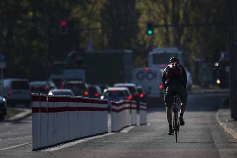 A cyclist is riding on a bicycle path on Holzmarktstrasse which is separated from the lanes for cars by bollards Berlin 17 04 2019 Berlin Germany Copyright: xFlorianxGaertner photothek.netx