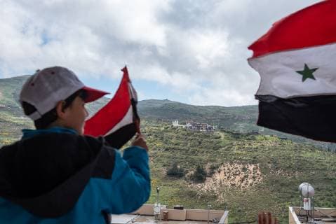 (190417) -- GOLAN HEIGHTS, April 17, 2019 -- A Druze resident of the Israeli-occupied Golan Heights attend a rally to mark Syria s Independence Day in the Druze village of Majdal Shams, April 17,2019. JINI Ayal Margolin) MIDEAST-GOLAN HEIGHTS-DRUZE RESIDENTS-RALLY guoyu 