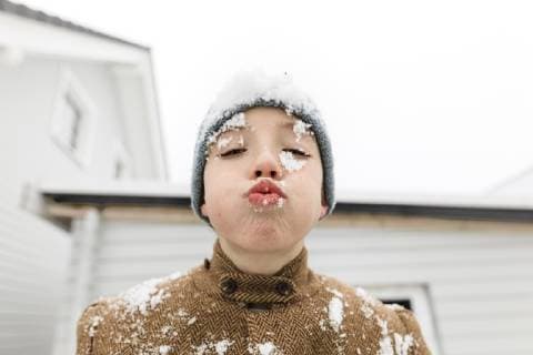 Portrait of boy with snow in his face model released Symbolfoto  KMKF00710