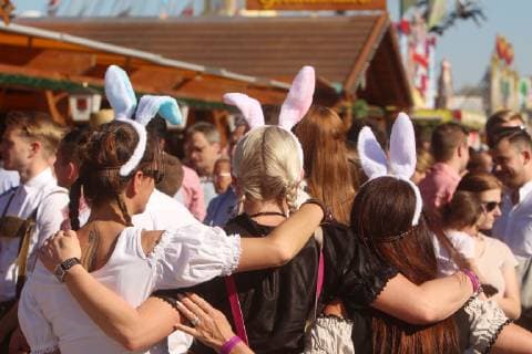 Cannstatter Wasen Spring festival on Easter Sunday in Stuttgart Bad Cannstatt Baden Württemberg Germany Women in Bavarian Dirndl wear matching rabbit ears on their heads on Easter Sunday