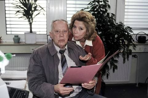 ADELHEID UND IHRE MÖRDER- Strobel (HEINZ BAUMANN) berichtet seiner Mannschaft von seinem neuesten Fahdungserfolg: Nach 10 Jahren ist es ihm gelungen, den Dieb seiner Schallplattensammlung zu verhaften. Doch seine Heldentat wird nicht gebührend beachtet. Hier mit Adelheid (EVELYN HAMANN). aka. Schuß in den Ofen 4 Überschrift: ADELHEID UND IHRE MÖRDER D 1998 Copyright: KPA !AUFNAHMEDATUM GESCHÄTZT! UnitedArchives00888977