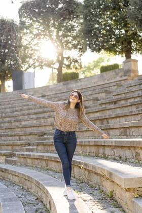 Happy young woman balancing on stairs outdoors model released Symbolfoto  AFVF02440