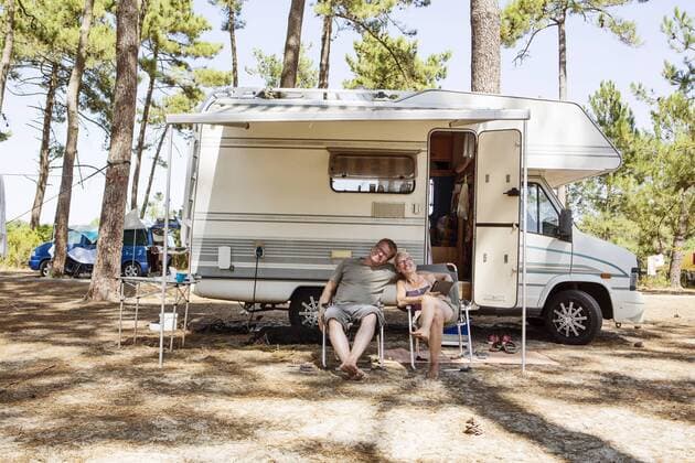 France, Gironde, happy couple sitting in front of camper on camping ground model released Symbolfoto property released  JATF01135