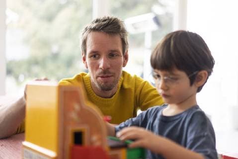 Father and son playing with a toy till model released Symbolfoto property released  JOSF03086