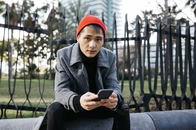 Spain, Barcelona, portrait of fashionable young man with cell phone model released Symbolfoto  JRFF02489