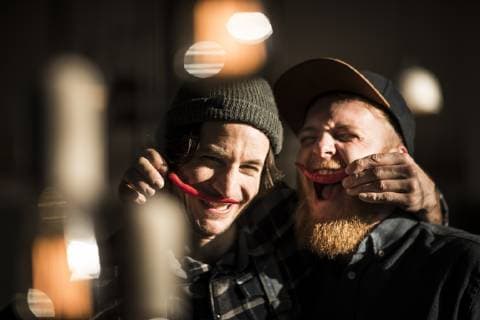 Friends playing with chili peppers making moustaches model released Symbolfoto property released  MJRF00039