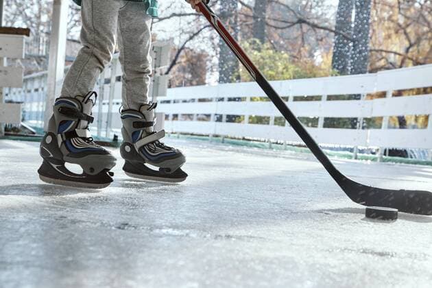 Boy playing ice hockey, low section model released Symbolfoto property released  ZEDF01795