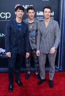 (L-R) Joe Jonas, Nick Jonas and Kevin Jonas arrive for the 2019 Billboard Music Awards at the MGM Grand Garden Arena in Las Vegas, Nevada on May 1, 2019.  LAV20190501039 JIMxRUYMEN