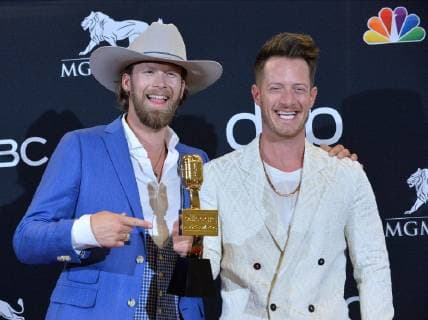 Brian Kelley (L) and Tyler Hubbard of Florida Georgia Line appear backstage after winning the award for Best Country Song for Meant to Be, during the 2019 Billboard Music Awards at the MGM Grand Garden Arena in Las Vegas, Nevada on May 1, 2019.  LAV20190501181 JIMxRUYMEN