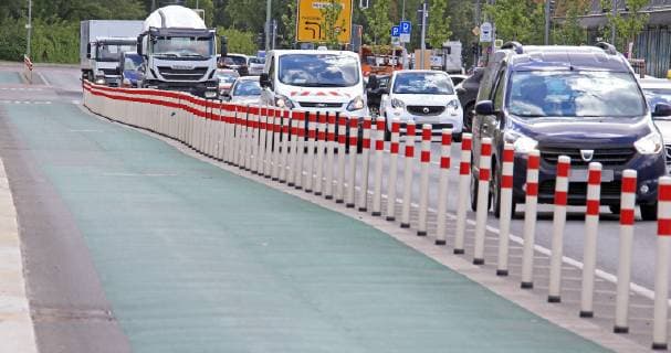 Protected Bike Lane 03 05 2019 green bicycle path on Holzmarkstrasse in Friedrichshain with barriers to road traffic Berlin Berlin Germany Friedrichshain
