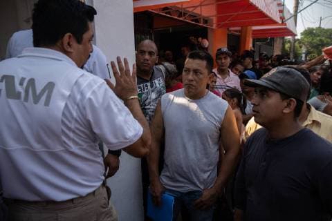 Javier Valdez holds a list of names in front of INM s Regional Sub-delegation office in Tapachula, Mexico on May 6, 2019. Valdez calls the names of people so they can speak to someone about having the proper paperwork to be in Mexico. Some migrants enter Mexico at this southern border town and then travel freely north to the United States border.  TP2019050610555 ARIANAxDREHSLER