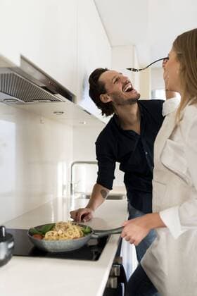 Happy couple preparing spaghetti in their kitchen model released Symbolfoto property released  VABF02129