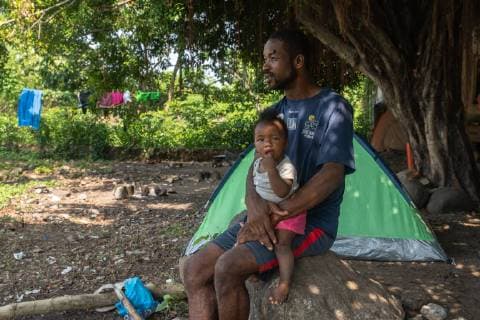 Cineac Kinchel from Haiti sits with his daughter Michele in Tapachula, Mexico on May 9, 2019. Kinchel s and his daughter have been staying where other migrants from Africa and Haiti have temporarily settled near the (INM) Instituto Nacional de Migracion Delegacion Federal en Chiapas building while hoping to apply for an exit visa so they can make their way to the US-Mexico border.  TP2019050906 ARIANAxDREHSLER