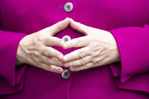 Chancellor Angela Merkel makes the rhombus as she poses for a picture in Berlin on 16 May 2019 Chancellor visits Museum of Natural History in Berlin