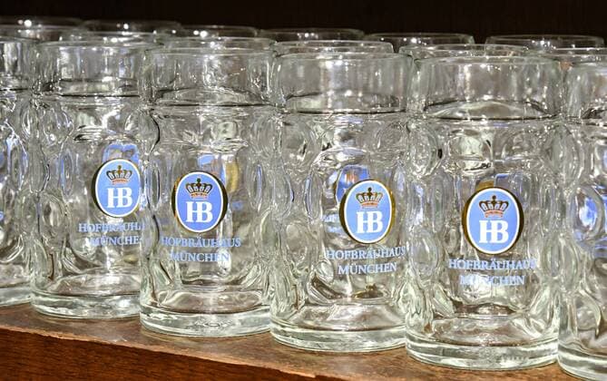 Masskrüge are on a shelf in the Hofbräuhaus in Munich