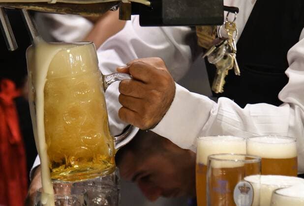 Hofbräuhaus Munich fresh Hofbräu beer runs from the tap into a beer mug,