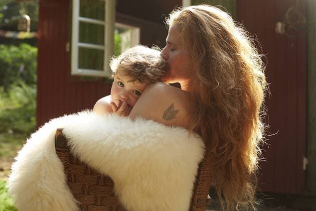 Mother and little daughter cuddling outside holiday home model released Symbolfoto property released  AMEF00038