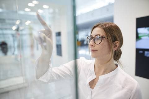 Young businesswoman touching virtual touchscreen model released Symbolfoto  PNEF01375