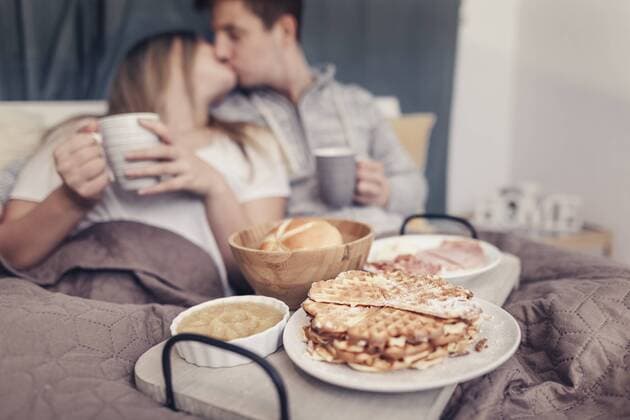 Affectionate young couple having breakfast in bed model released Symbolfoto property released  SEBF00081