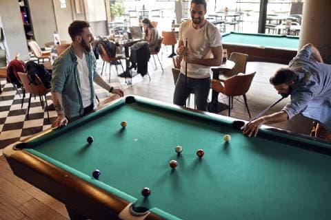 Friends playing billiards together model released Symbolfoto property released  ZEDF02049