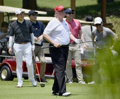 Trump in Japan U.S. President Donald Trump (C) and Japanese Prime Minister Shinzo Abe (L) play golf at Mobara Country Club in Chiba Prefecture, near Tokyo, on May 26, 2019, their fifth round together since Trump took office in 2017. 