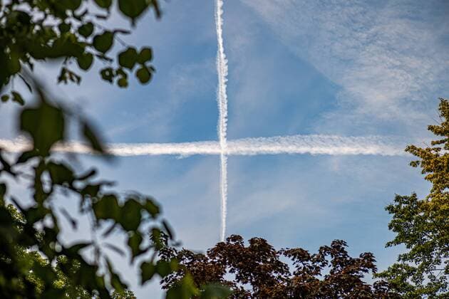 Condensation trails from airplanes in the sky, Berlin Tempelhof Berlin Germany