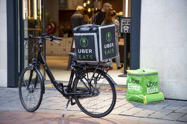 Amsterdam, Netherlands, Couriers of food online delivery service via Eats, bicycle supplier and delivery courier on foot,
