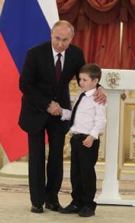 MOSCOW, RUSSIA - MAY 30, 2019: Russia s President Vladimir Putin shakes hands with a boy at a ceremony to present Orders of Parental Glory to parents of large families at the Moscow Kremlin. Mikhail Metzel TASS  TS0AD500