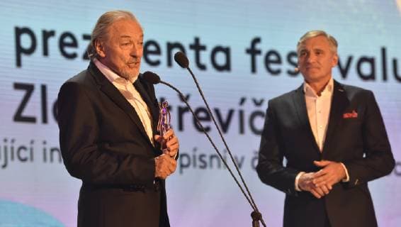 Czech singer Karel Gott, left, takes the Golden Slipper award for exceptional interpretation of songs in Czech films, within the 59th Zlin Film Festival - International film festival for children and youth, in Zlin, Czech republic, on May 31, 2019. On the right side is seen moderator Jan Censky. (CTKxPhoto DaliborxGluck) CTKPhotoP201905311088801  dg002A