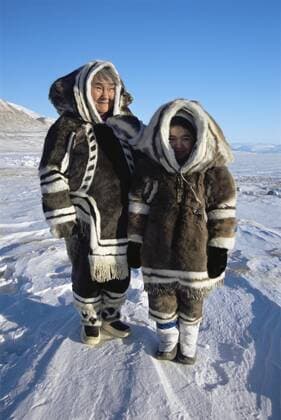 CANADA Inuit women in traditional caribou clothing and sealskin boots kamiks, Lancaster Sound, Nunavut, Canadian high Arctic, March 2004  1276568 SuexFloodx-xTD