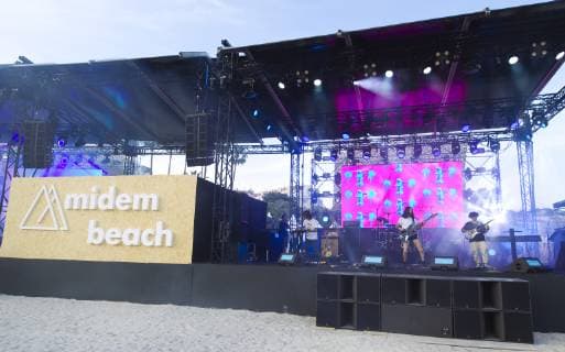 Cannes, France - June 04, 2019: MIDEM, the International B2B Music Market. MIDEM by Night Beach Concert with Neon Garden, Panda Glasses and Qing Mu MIDEM, the International B2B Music Market