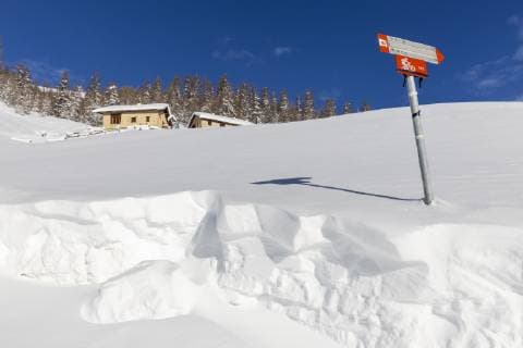 Traditional huts with trekking signal in winter, Livigno, Valtellina, Lombardy, Italy, Europe Copyright: FrancescoxBergamaschi 1269-461