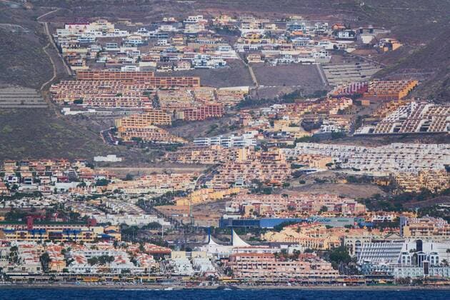 Hotels with swimmimg pool , beach and park with tourists sunbathing in Adeje, Tenerife, Spain, March 16, 2019. Photographer: Peter Schatz