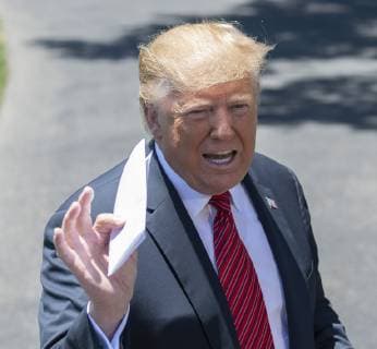President Donald Trump holds up a letter that he says is the secret agreement with Mexico that put on hold the increase in tariffs, during an impromptu press conference on the South Lawn of the White House in Washington, DC on June 11, 2019. He then departed for Iowa.  WAS2019061102 PATxBENIC