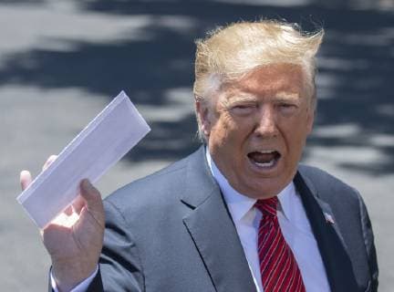 President Donald Trump holds up a letter that he says is the secret agreement with Mexico that put on hold the increase in tariffs, during an impromptu press conference on the South Lawn of the White House in Washington, DC on June 11, 2019. He then departed for Iowa.  WAS2019061104 PATxBENIC