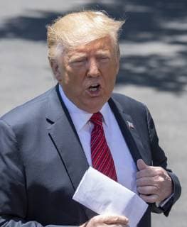 President Donald Trump pulls out a letter that he says is the secret agreement with Mexico that put on hold the increase in tariffs, during an impromptu press conference on the South Lawn of the White House in Washington, DC on June 11, 2019. He then departed for Iowa.  WAS2019061105 PATxBENIC