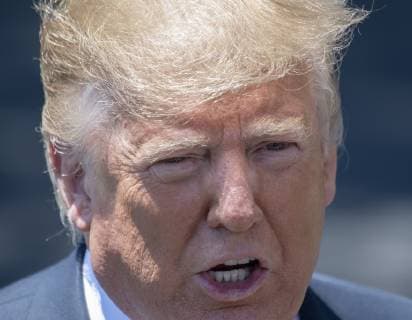 President Donald Trump s hair blows in the wind as he responds to a reporter s question during an impromptu press conference on the South Lawn of the White House in Washington, DC on June 11, 2019. He then departed for Iowa.  WAS2019061110 PATxBENIC