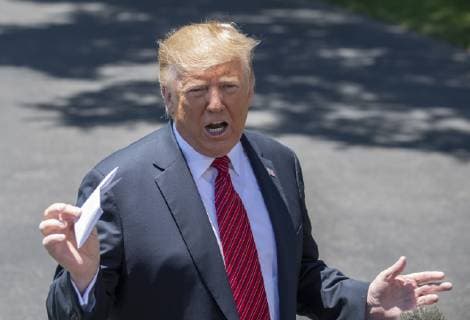 President Donald Trump holds up a letter that he says is the secret agreement with Mexico that put on hold the increase in tariffs, during an impromptu press conference on the South Lawn of the White House in Washington, DC on June 11, 2019. He then departed for Iowa.  WAS2019061108 PATxBENIC