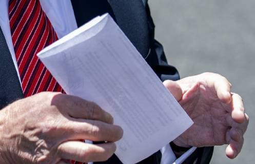 President Donald Trump holds up a letter that he says is the undisclosed agreement with Mexico that put on hold the increase in tariffs, during an impromptu press conference on the South Lawn of the White House in Washington, DC on June 11, 2019. He then departed for Iowa.  WAS2019061114 PATxBENIC