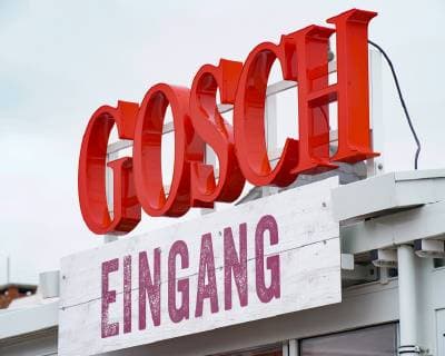 Jürgen Gosch successful owner, entrepreneur, fish handler and visionary of the Gosch brand of the same name at his location on Sylt List in chefs jacket with company logo Sylt List Nordfriesland Germany