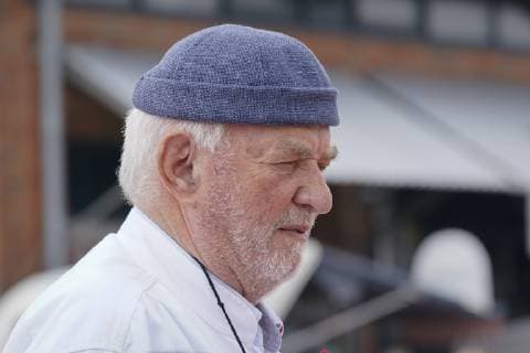 Jürgen Gosch successful owner, entrepreneur, fish handler and visionary of the Gosch brand of the same name at his location on Sylt List in chefs jacket with company logo Sylt List Nordfriesland Germany