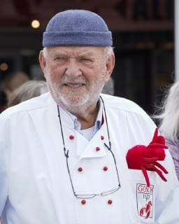 Jürgen Gosch successful owner, entrepreneur, fish handler and visionary of the Gosch brand of the same name at his location on Sylt List in chefs jacket with company logo Sylt List Nordfriesland Germany