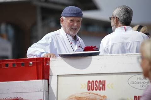 Jürgen Gosch successful owner, entrepreneur, fish handler and visionary of the Gosch brand of the same name at his location on Sylt List in chefs jacket with company logo Sylt List Nordfriesland Germany