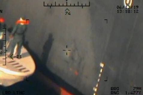 June 13, 2019 - Gilf of Oman - Imagery taken from a U.S. Navy MH-60R helicopter of the Islamic Revolutionary Guard Corps Navy removing an unexploded limpet mine from the M T Kokuka Courageous. Gilf of Oman - ZUMAz03_ 20190613_sha_z03_286 Copyright: xDoDx