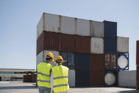 Workers in front of cargo containers on industrial site model released Symbolfoto property released  AHSF00178