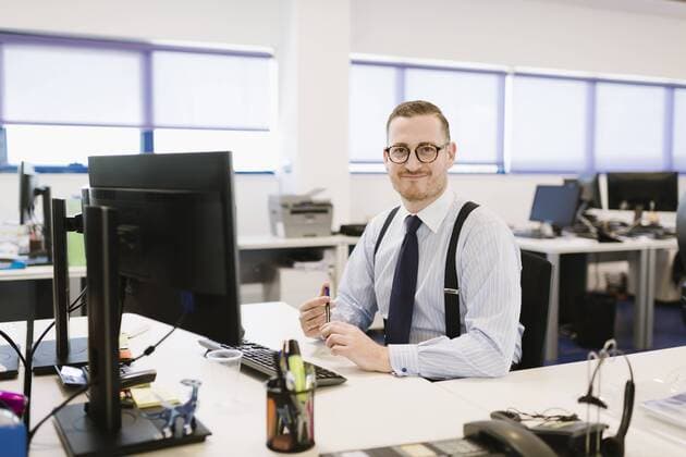Portrait of confident businessman at desk in office model released Symbolfoto property released  AHSF00236