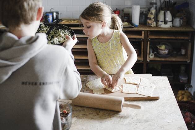Little girl and her older brother preparing stuffed pastry in the kitchen model released Symbolfoto property released  KMKF00911