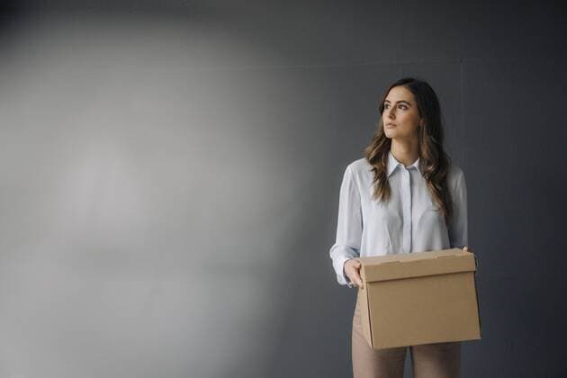 Serious young businesswoman holding cardboard box model released Symbolfoto property released  KNSF05781