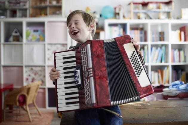 Boy exercising on his accordeon model released Symbolfoto property released  RBF07023